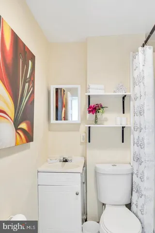 a white toilet sitting next to a bathroom sink