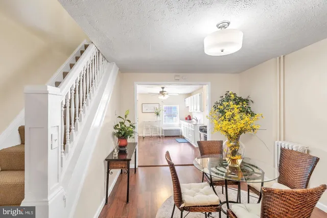 a dining room with furniture and wooden floor
