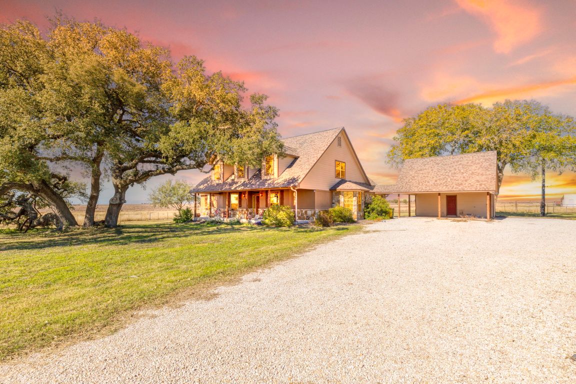 a view of a house with pool and a yard