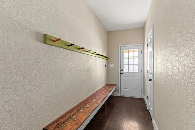 a view of a room with wooden floor and stairs
