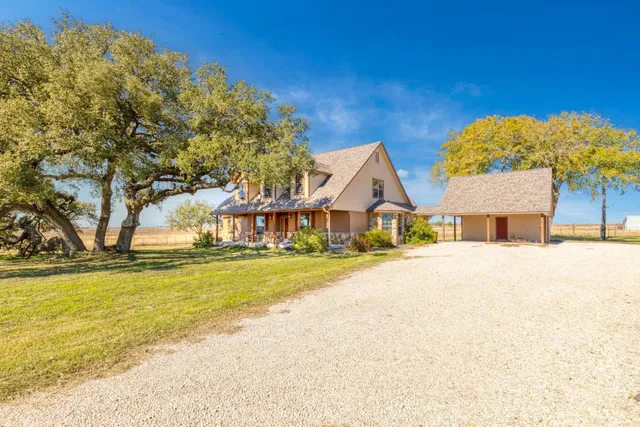 a front view of a house with a garden and swimming pool