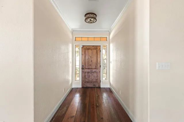 a view of a hallway with wooden floor