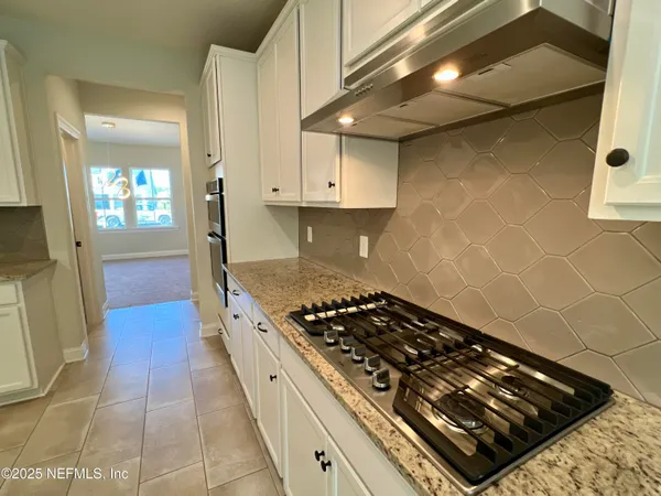 a kitchen with granite countertop a stove and a sink