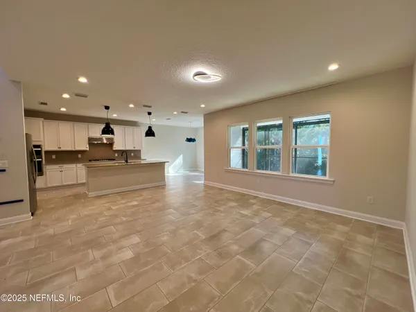 a view of kitchen with stainless steel appliances a refrigerator and a stove top oven