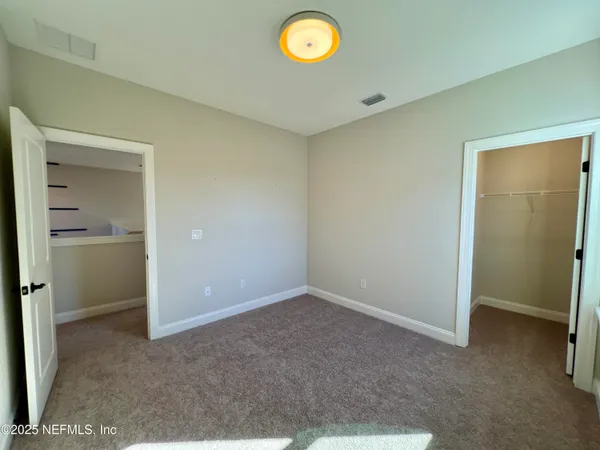 a view of an empty room and a window