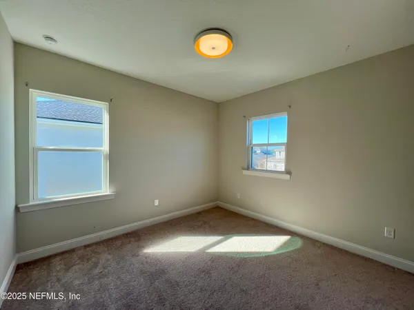 a bathroom with a granite countertop toilet a sink and a mirror