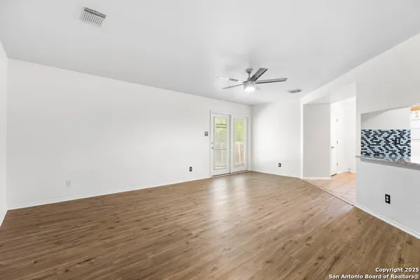 a view of kitchen with cabinets and wooden floor