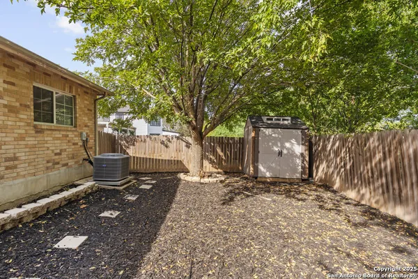 a backyard of a house with barbeque oven