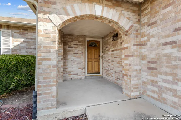 an empty room with wooden floor and a ceiling fan