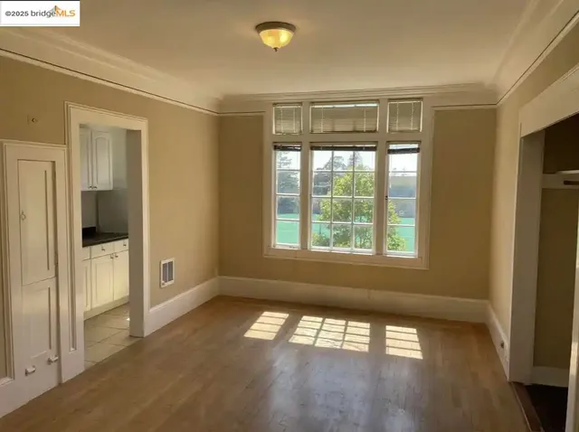 an empty room with closet and wooden floor