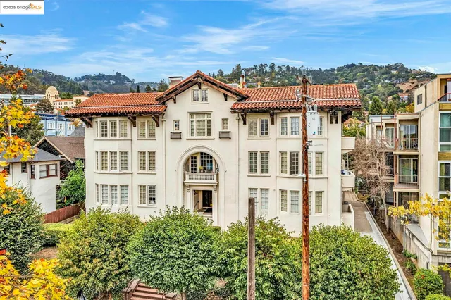 a view of a white building among the top of house