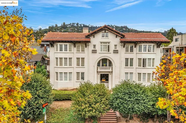 an aerial view of residential houses with a city view
