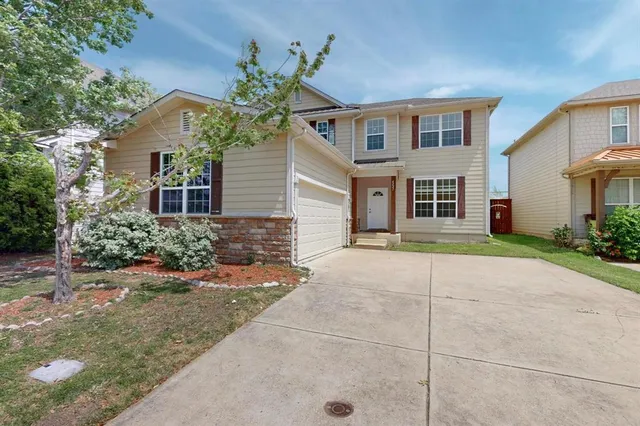 a house that has a tree in front of it