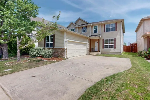 a front view of house with yard and trees around