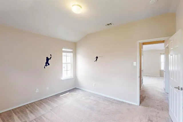 an empty room with windows and closet