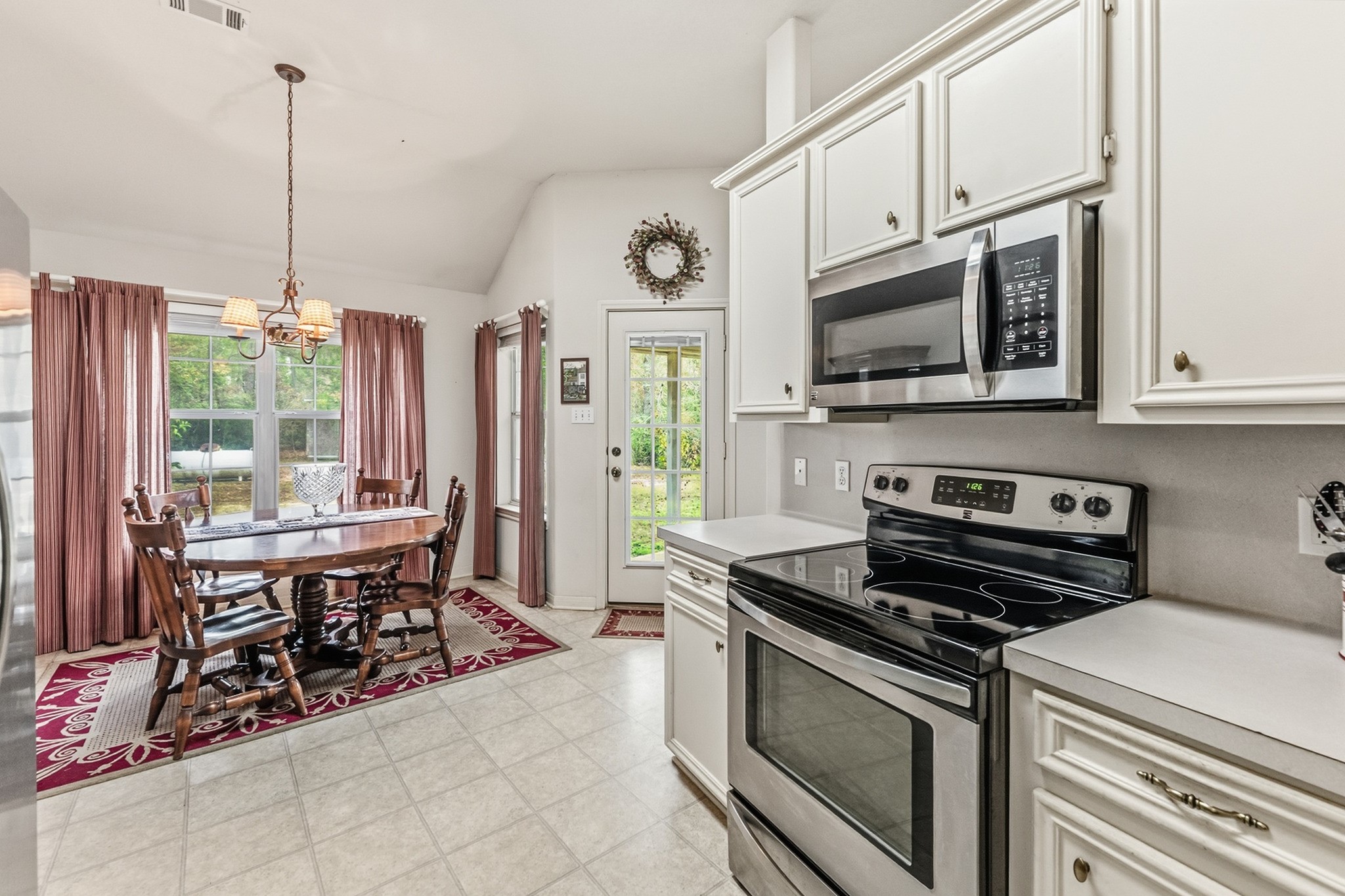 691 Bishop Road Huntsville, TX 77320 - Photo 11 of 32 a kitchen with stainless steel appliances a stove a sink and a white cabinets