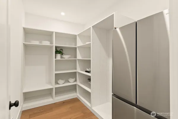 a view of walk in closet with empty racks