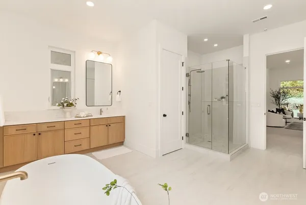 a spacious bathroom with a double vanity sink mirror and shower