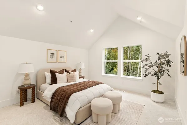 a bedroom with a bed and a potted plant