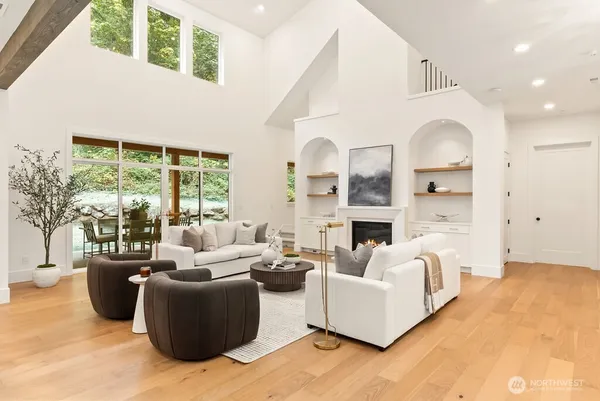 a living room with furniture fireplace and a large window