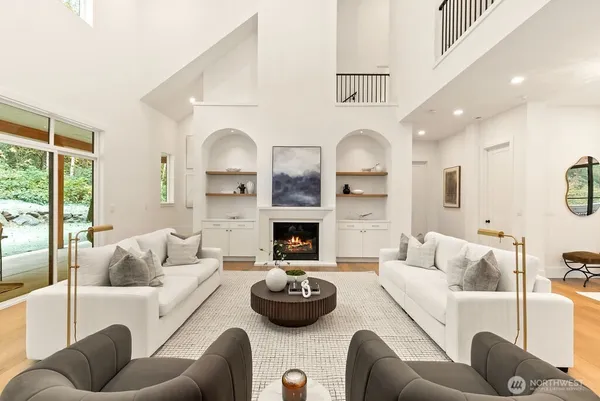 a living room with furniture fireplace and window