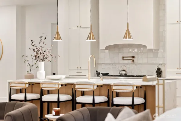 a kitchen with stainless steel appliances kitchen island granite countertop a sink and cabinets