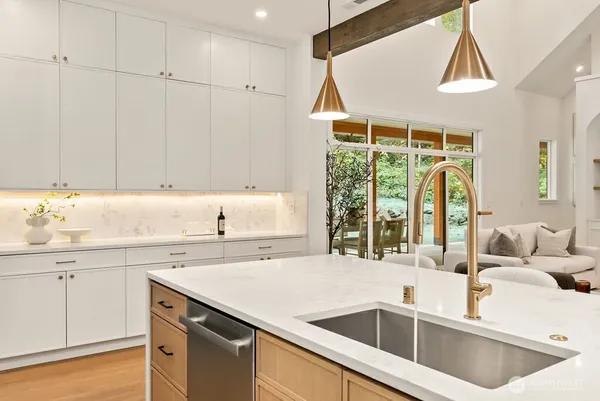 a kitchen with a sink cabinets and window