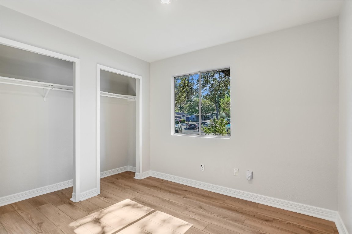 736 Wales Way Austin, TX 78748 - Photo 15 of 25 a view of an empty room with wooden floor and a window