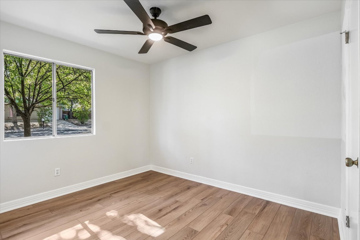 736 Wales Way Austin, TX 78748 - Photo 17 of 25 an empty room with a window and a ceiling fan