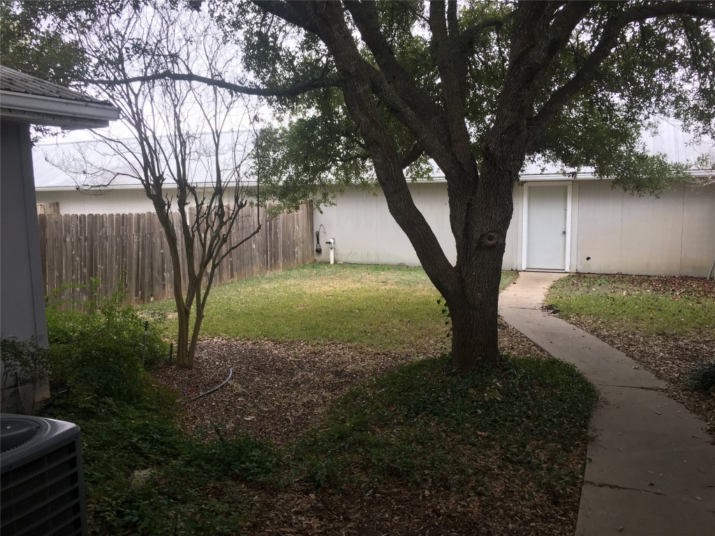 5251 Hwy 290 W Dripping Springs West, Unit 1 Dripping Springs, TX 78620 - Photo 1 of 15 a view of a tree in a yard