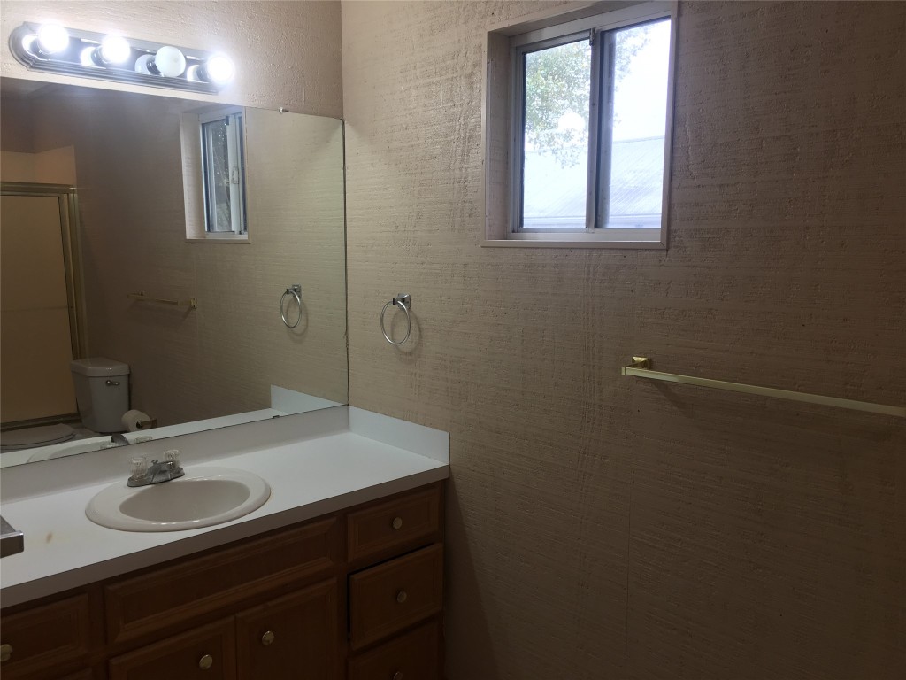 5251 Hwy 290 W Dripping Springs West, Unit 1 Dripping Springs, TX 78620 - Photo 11 of 15 a bathroom with a sink and a mirror