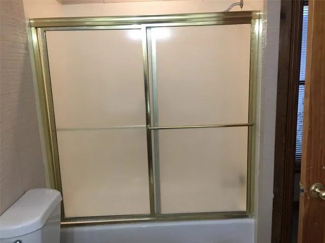 a bathroom with a glass shower door