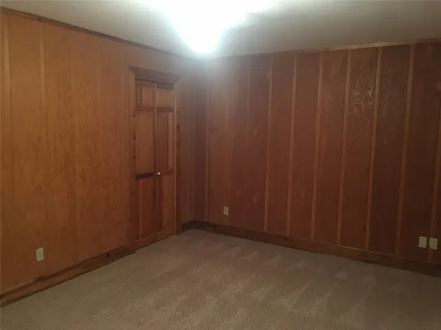 an empty room with a wooden door