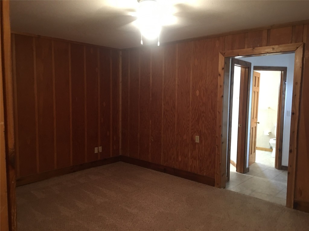 5251 Hwy 290 W Dripping Springs West, Unit 1 Dripping Springs, TX 78620 - Photo 14 of 15 a view of an empty room with wooden walls
