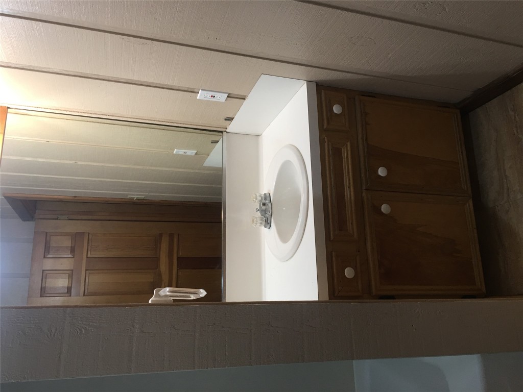 5251 Hwy 290 W Dripping Springs West, Unit 1 Dripping Springs, TX 78620 - Photo 3 of 15 a bathroom with a sink and a mirror