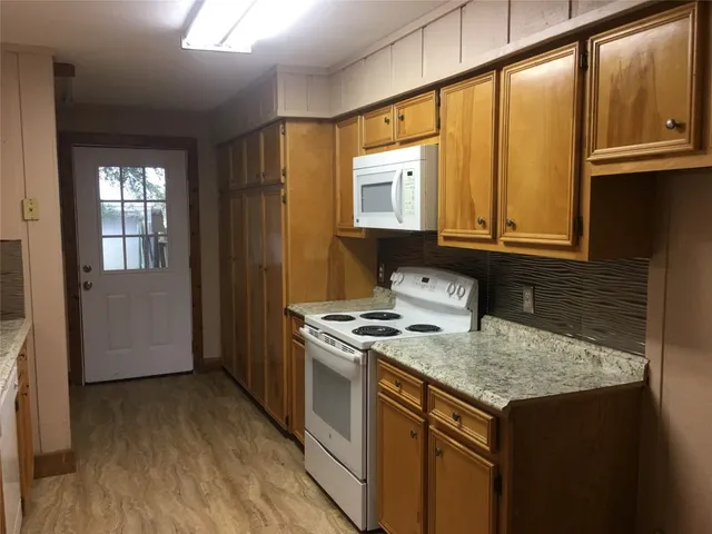 a kitchen that has a cabinets and a stove