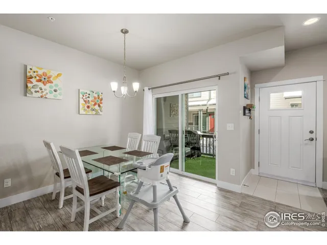 a view of a dining room with furniture and front door