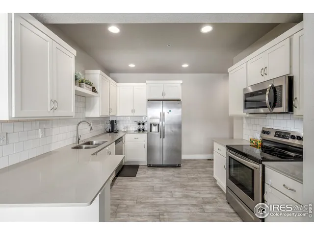 a kitchen with a sink stainless steel appliances and cabinets