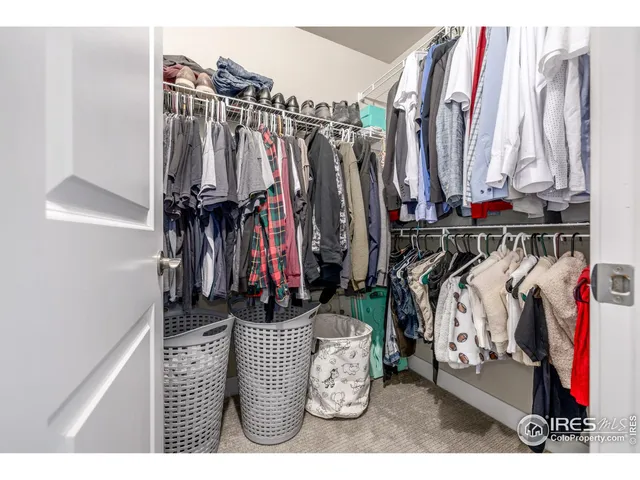 a view of walk in closet with clothes