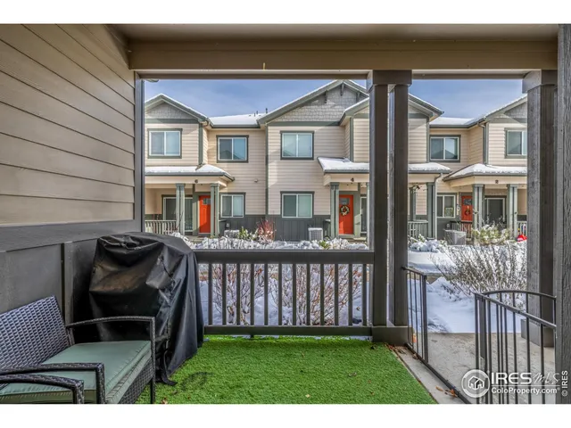 a view of a house with wooden deck and furniture