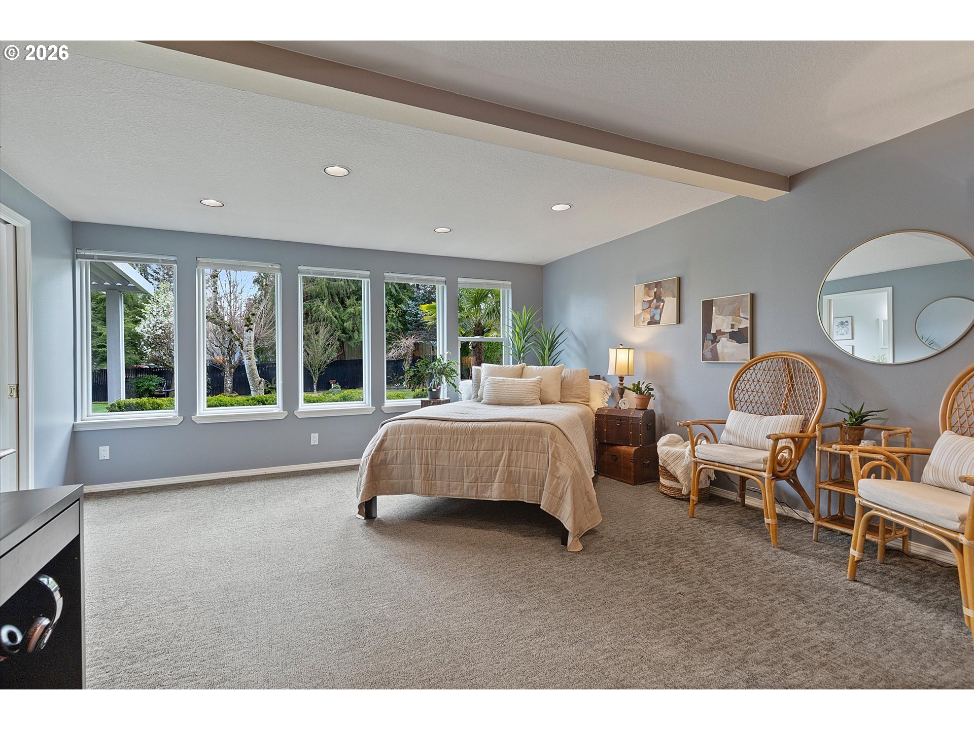 10540 Southwest Errol Street Tigard, OR 97223 - Photo 17 of 47 a spacious bedroom with a large bed and a large window