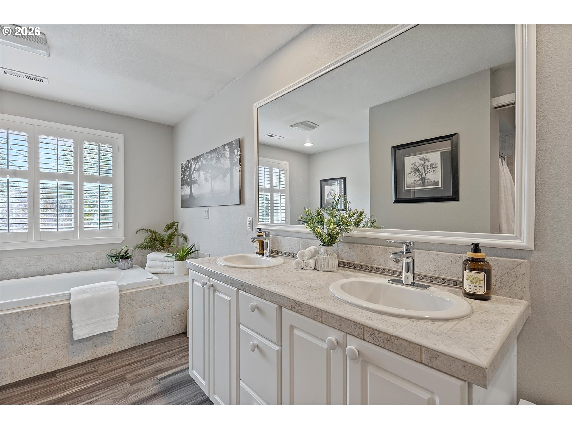 10540 Southwest Errol Street Tigard, OR 97223 - Photo 24 of 47 a bathroom with a sink double vanity granite tub and a window