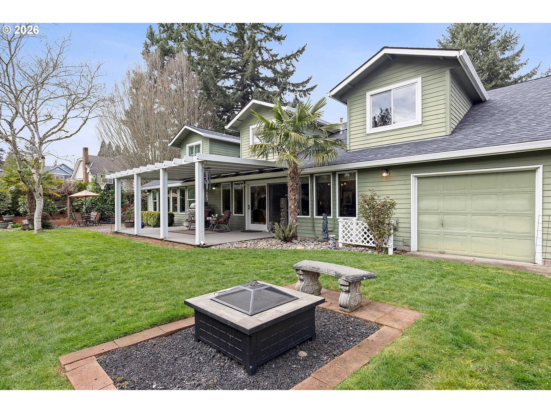 10540 Southwest Errol Street Tigard, OR 97223 - Photo 35 of 47 a front view of a house with a yard table and chairs