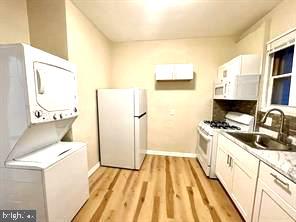 a kitchen with a sink a stove and a refrigerator