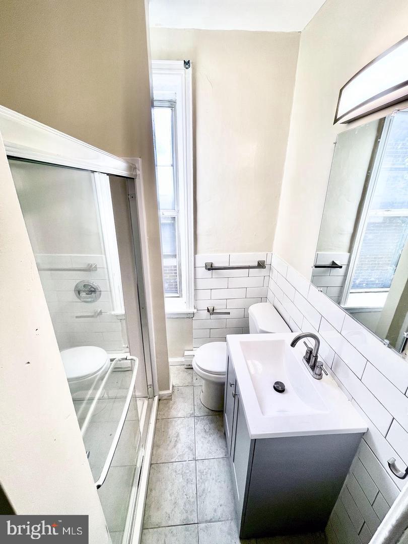 3151 G Street Philadelphia, PA 19134 - Photo 16 of 16 a bathroom with a sink a toilet and a mirror