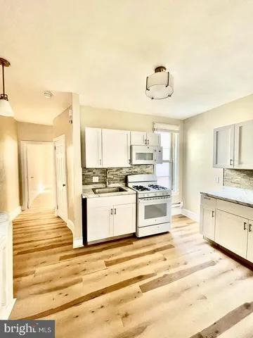 a kitchen with stainless steel appliances granite countertop a stove and cabinets