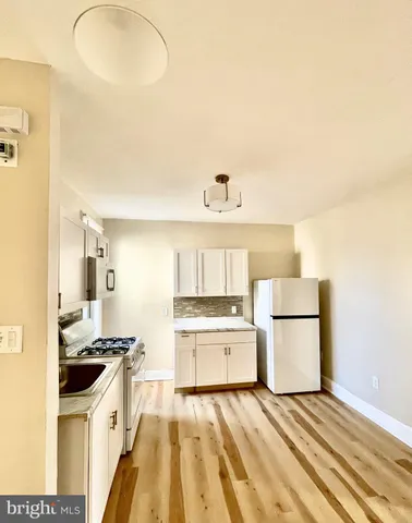 a kitchen with a stove a sink and a refrigerator