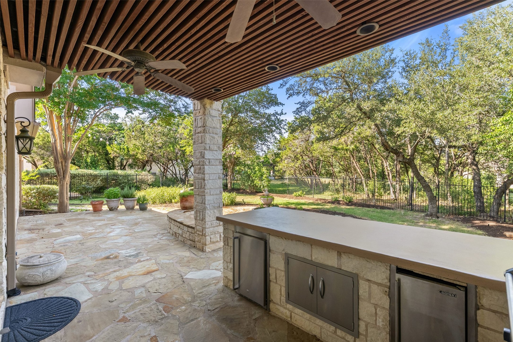 8215 Dark Ridge Cove Austin, TX 78737 - Photo 35 of 40 An inviting large patio features a covered outdoor kitchen with a built-in grill.