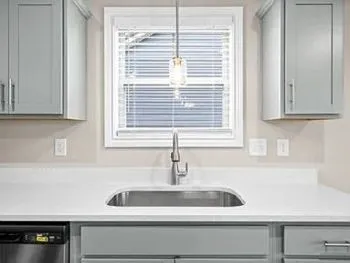 a kitchen with a sink and cabinets