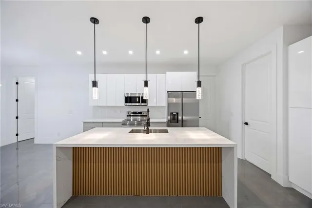 a kitchen with a sink a stove and a refrigerator